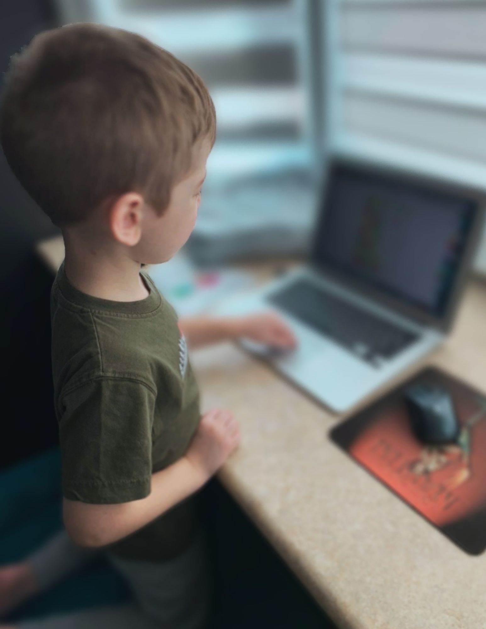 Image of small child at a laptop